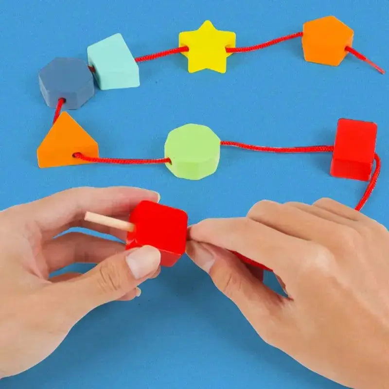 Colorful shapes on string for threading activity.