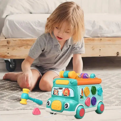 Child playing with green shape sorter bus toy