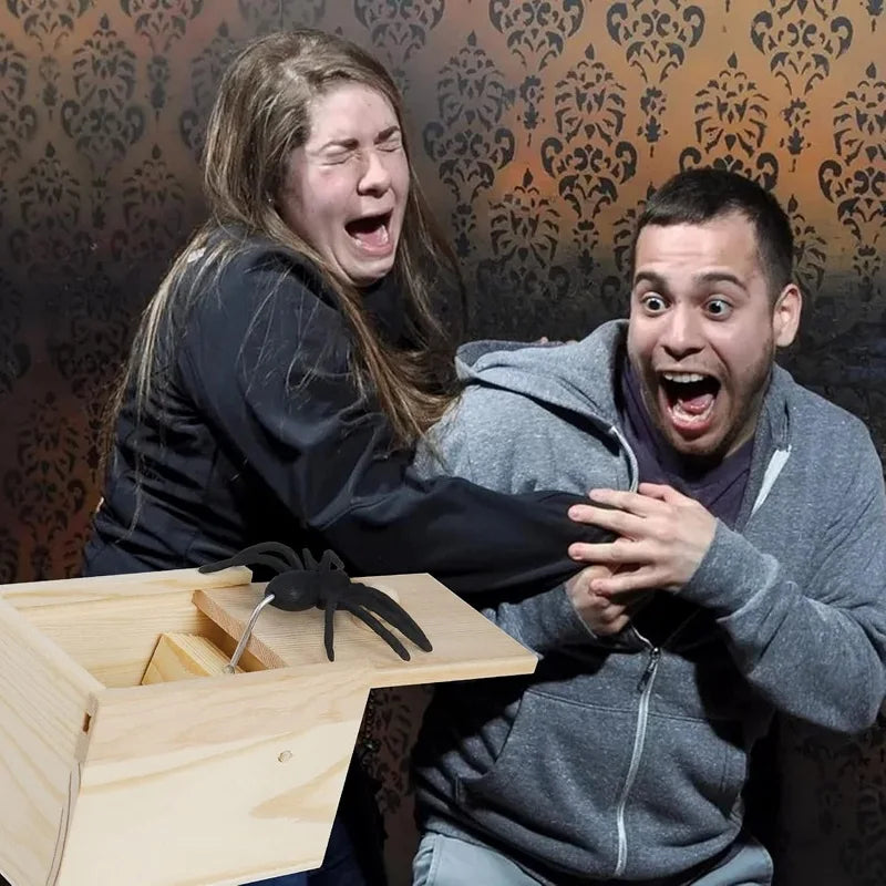 Two people reacting with surprise and laughter to a wooden prank box with a jumping spider. A hilarious gift for parties and practical jokes.