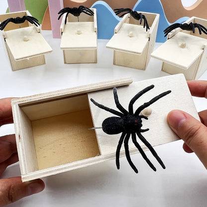 Multiple wooden prank boxes with realistic black spiders, showcasing the spring-loaded surprise mechanism. Great for parties and practical jokes.