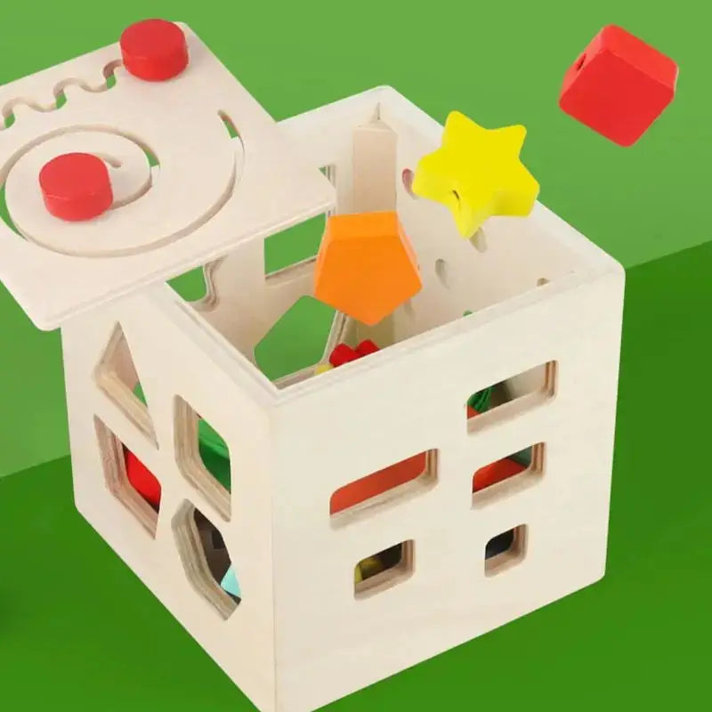 Open wooden shape sorter cube with shapes inside.