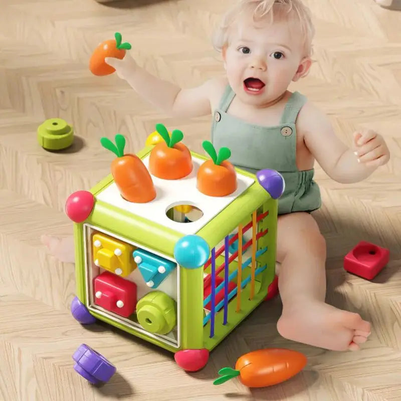 Baby playing with Montessori shape sorter cube.