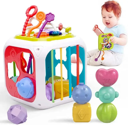 Colorful shape sorter cube with additional toys.