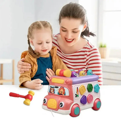 Mother and child playing with pink shape sorter bus